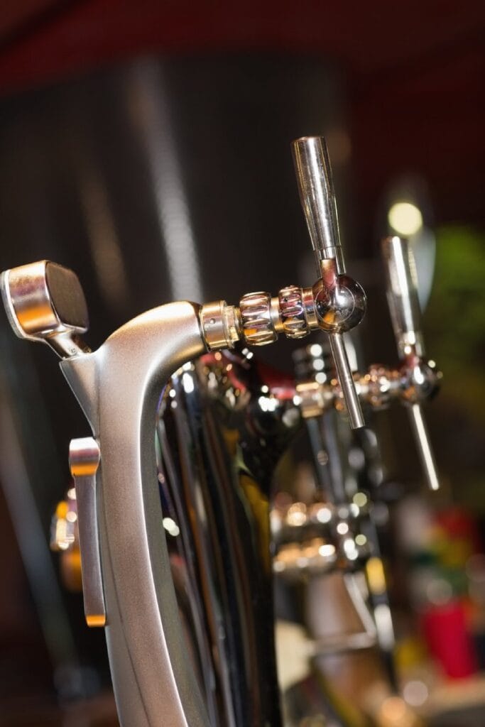 Close-up of shiny beer taps in a row at a Barossa Valley brewery, showcasing the variety and craftsmanship of local craft beer.