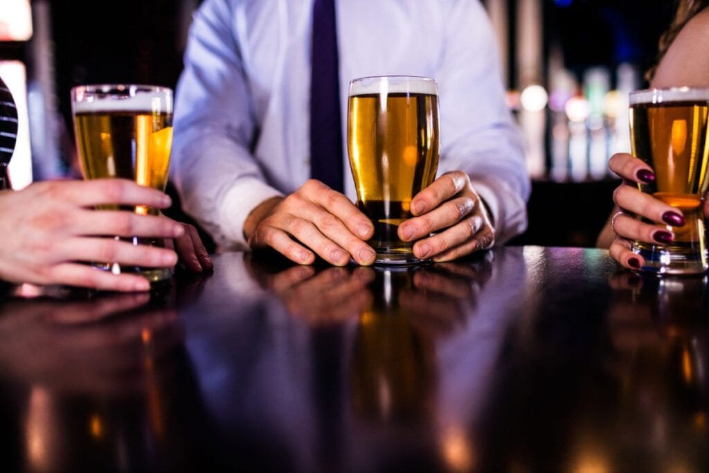 Friends enjoying freshly poured craft beers at a popular Barossa Valley brewery, reflecting the vibrant social scene and local beer culture.