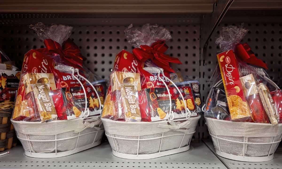 Festive display of the best Christmas hampers in Adelaide, filled with delicious treats and beautifully wrapped with red ribbons.