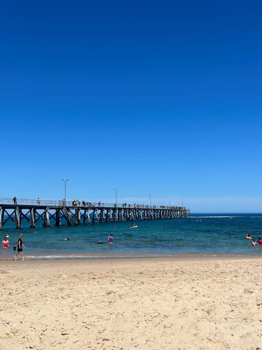 port noarlunga beach Port Noarlunga Beach with visitors enjoying the clear waters and the iconic jetty, showcasing its reputation as one of the best beaches in the Fleurieu Peninsula for family outings and water activities.