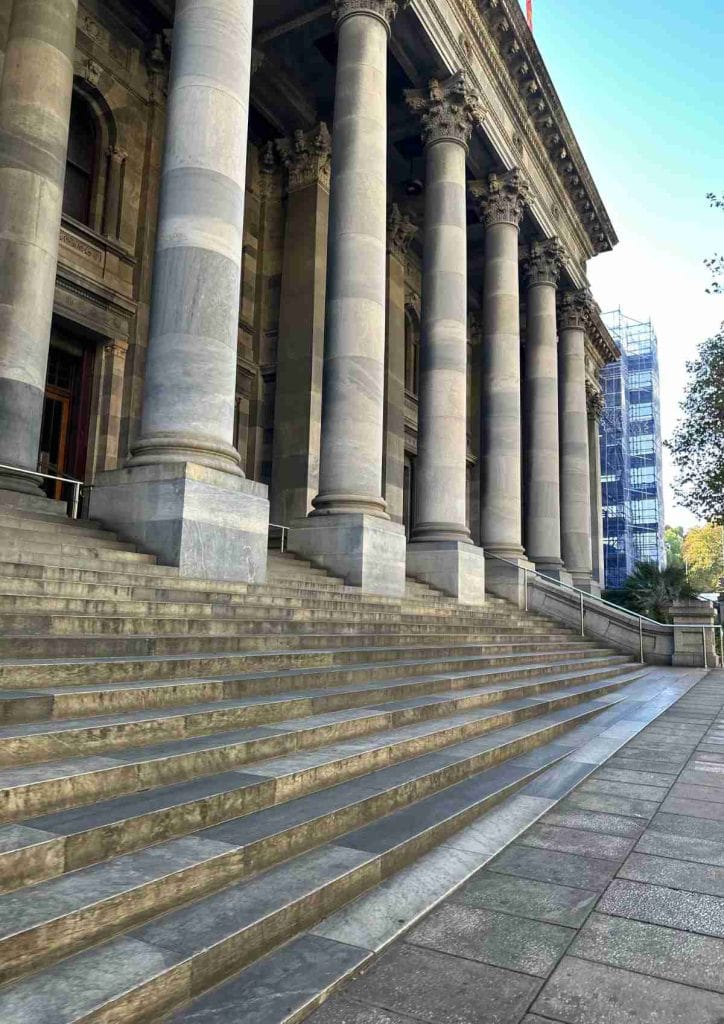 Front view of Parliament House in Adelaide, featuring grand marble steps and towering Corinthian columns. This important civic building is one of the most iconic historic landmarks in Adelaide, representing the city’s political and architectural heritage.