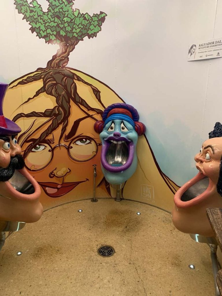 Quirky and artistic toilet installation featuring cartoon-like urinals and a surreal mural inside d’Arenberg Cube, showcasing the playful and creative side of one of the best SA wineries known for blending art, wine, and architecture.