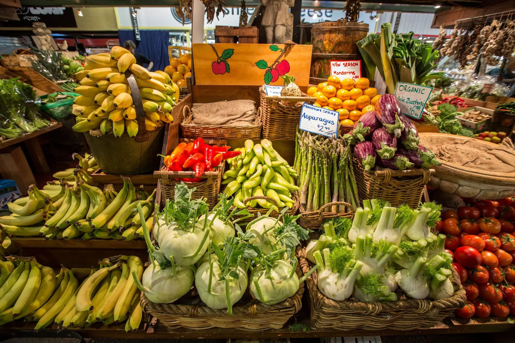 Colourful fresh produce displayed in wicker baskets at Adelaide Central Market with bananas. asparagus. eggplants. fennel. tomatoes. peppers. and other vegetables. Adelaide Central Market is a lively food stop to add to a 3 day Adelaide itinerary.